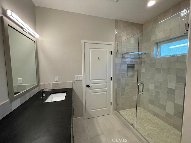 bathroom with a stall shower and vanity