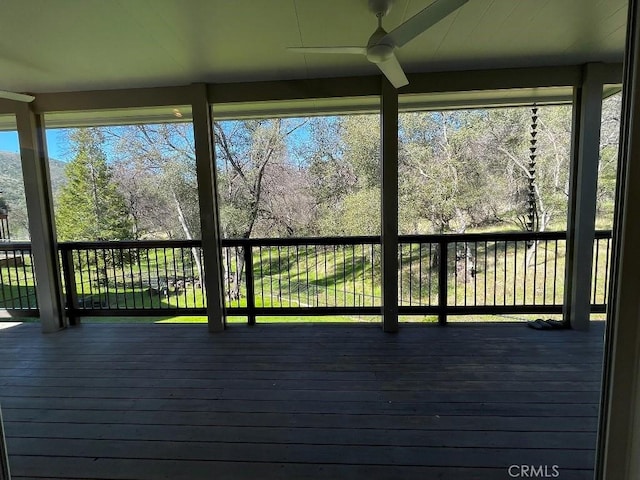 wooden terrace featuring a ceiling fan