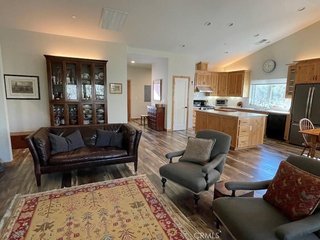 living area featuring high vaulted ceiling, recessed lighting, visible vents, and wood finished floors