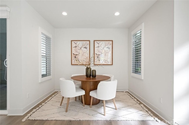 dining area with recessed lighting, a wealth of natural light, and baseboards