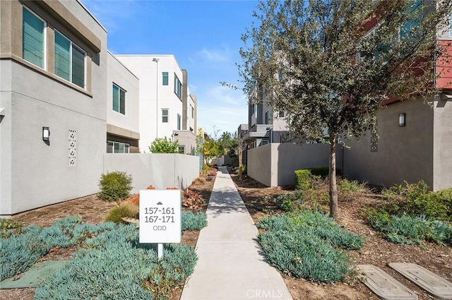 view of property's community featuring a residential view and fence