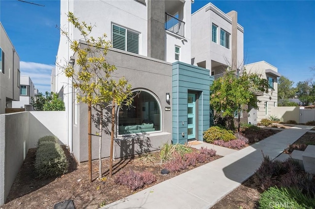 exterior space featuring fence and stucco siding