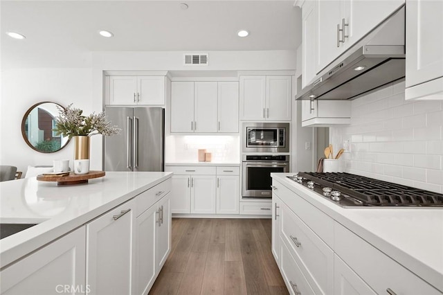 kitchen featuring visible vents, appliances with stainless steel finishes, and white cabinets