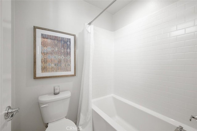 bathroom with shower / bath combo with shower curtain and toilet