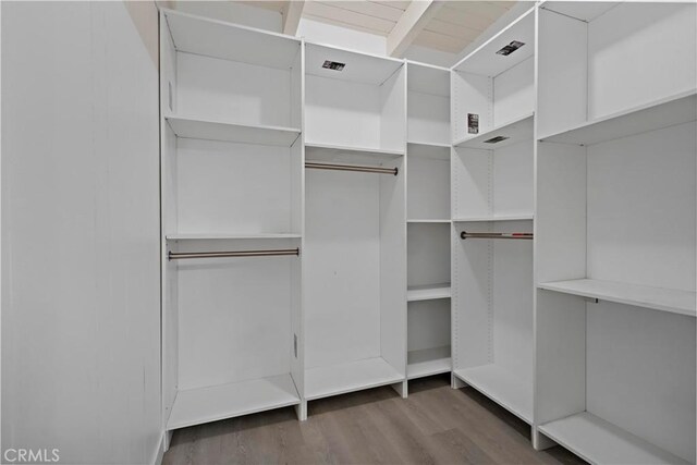 spacious closet featuring visible vents and wood finished floors