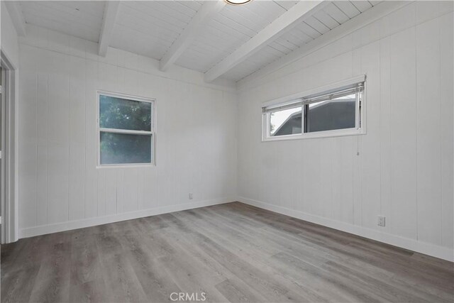 unfurnished room featuring wood ceiling, baseboards, beamed ceiling, and wood finished floors