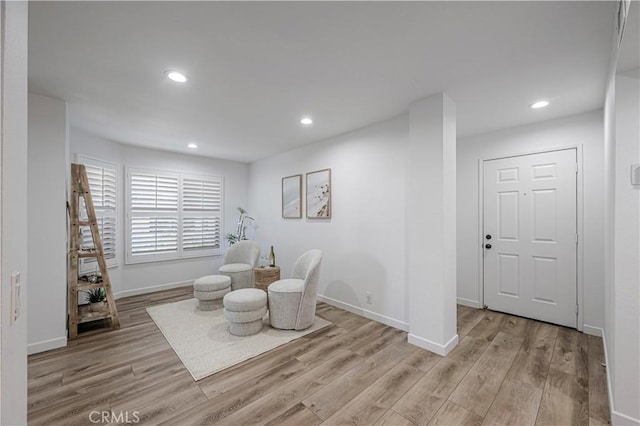 sitting room with light wood-style flooring, baseboards, and recessed lighting