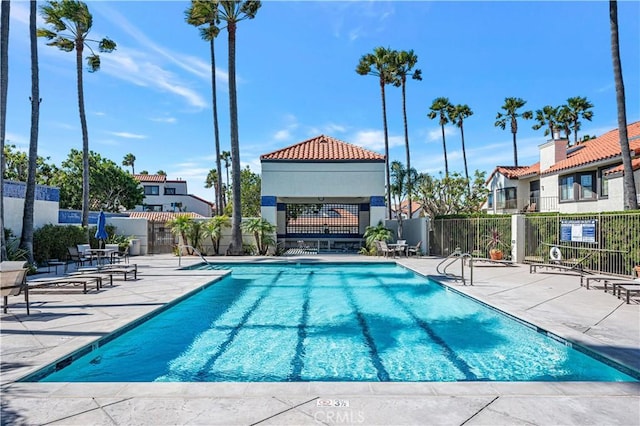 pool with fence and a patio