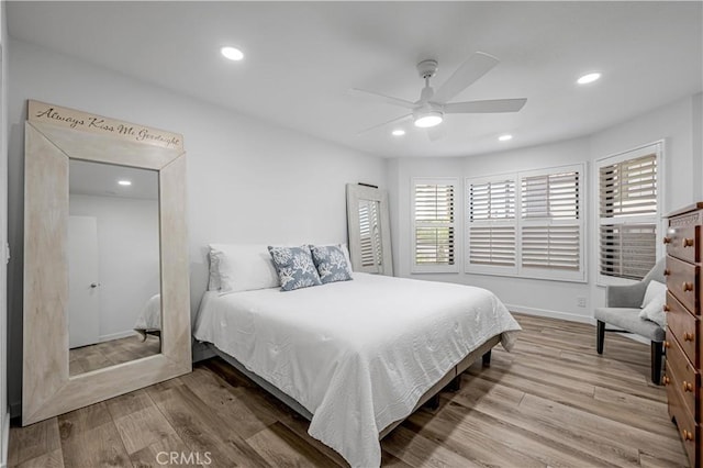 bedroom featuring ceiling fan, baseboards, wood finished floors, and recessed lighting