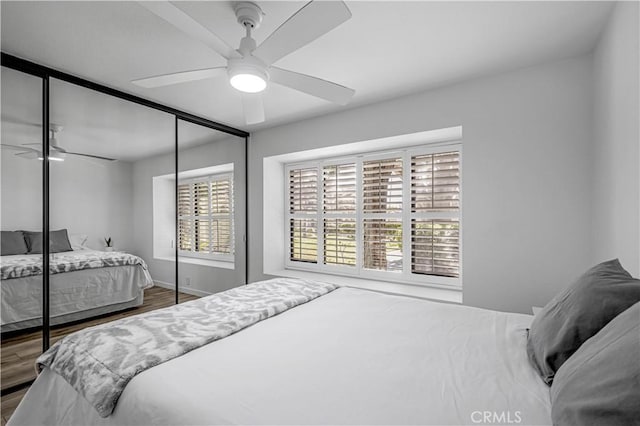 bedroom featuring ceiling fan, a closet, and wood finished floors