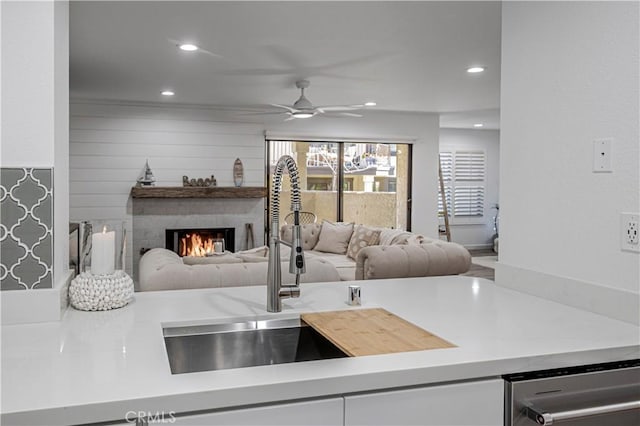 interior space with a large fireplace, ceiling fan, and recessed lighting