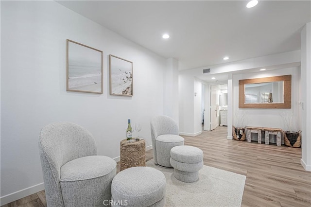 sitting room featuring recessed lighting, baseboards, and light wood finished floors