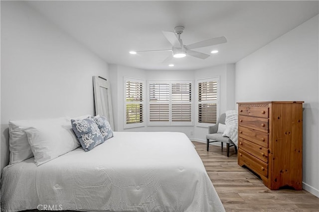 bedroom with baseboards, ceiling fan, wood finished floors, and recessed lighting