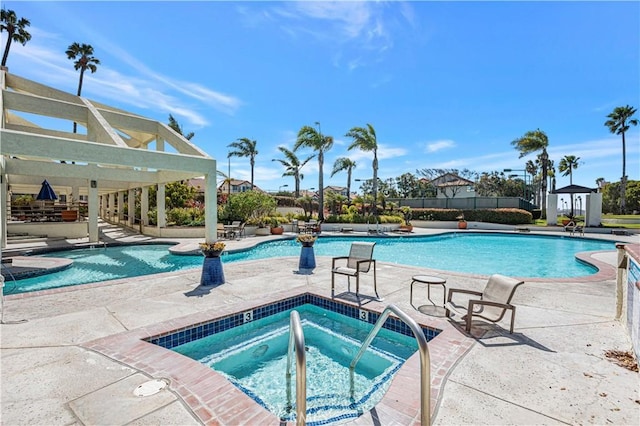 community pool featuring a community hot tub and a patio