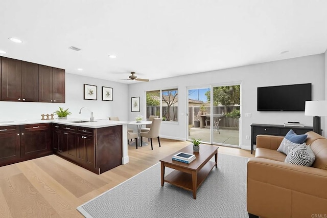 living area with a ceiling fan, visible vents, baseboards, recessed lighting, and light wood-style floors