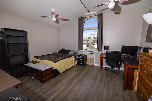 bedroom with lofted ceiling, a ceiling fan, and dark wood-style flooring