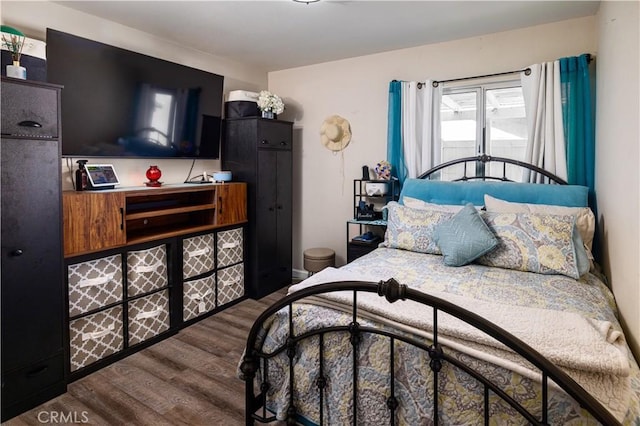 bedroom with dark wood-style flooring