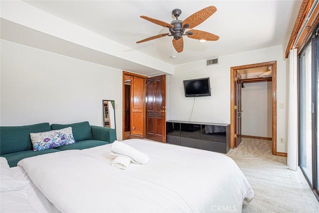 bedroom featuring ceiling fan, light colored carpet, visible vents, a spacious closet, and a closet