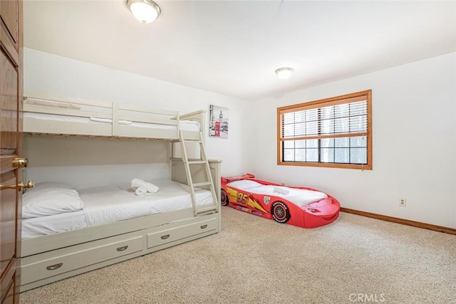 bedroom featuring carpet and baseboards