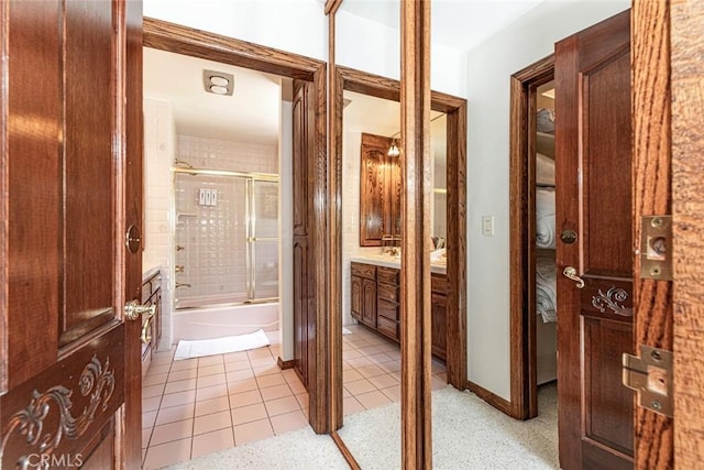 hall with light tile patterned floors