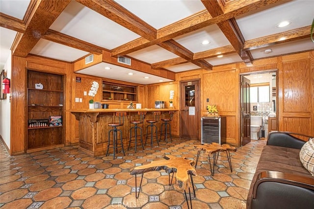 bar featuring wooden walls, visible vents, coffered ceiling, beamed ceiling, and built in shelves