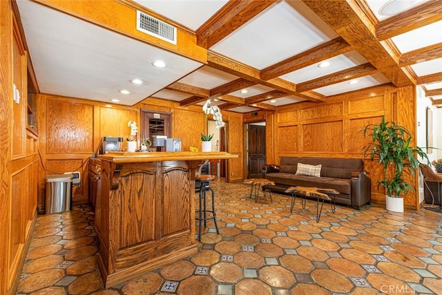 kitchen featuring visible vents, open floor plan, coffered ceiling, beamed ceiling, and a kitchen breakfast bar