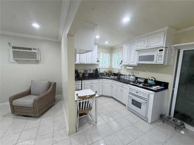 7844 Gainford St, Downey, CA 90240 - kitchen featuring white appliances, ornamental molding, dark countertops, white cabinetry, and an AC wall unit