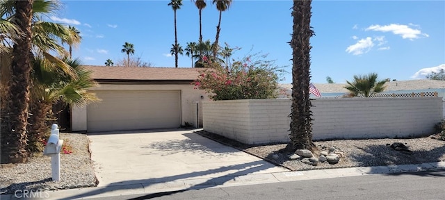 garage with fence and driveway