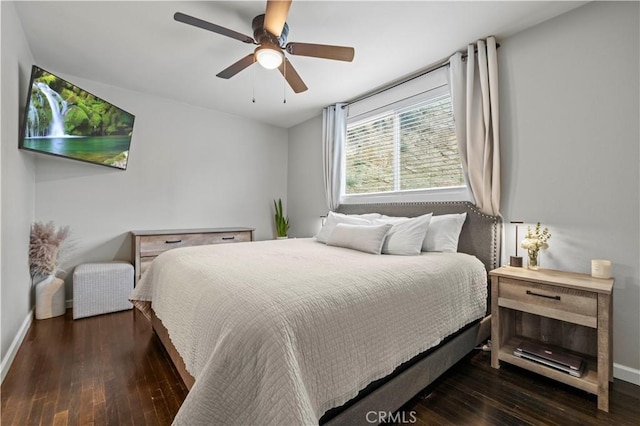 bedroom with a ceiling fan, baseboards, and hardwood / wood-style flooring