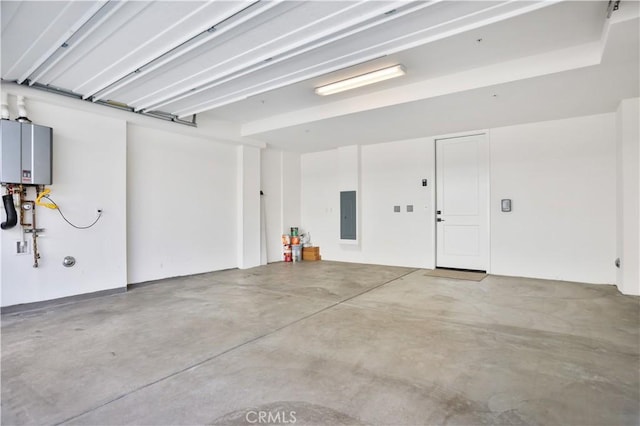 garage featuring electric panel and water heater