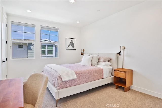 bedroom featuring recessed lighting, light colored carpet, and baseboards