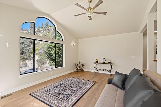 living area with plenty of natural light, visible vents, and wood finished floors