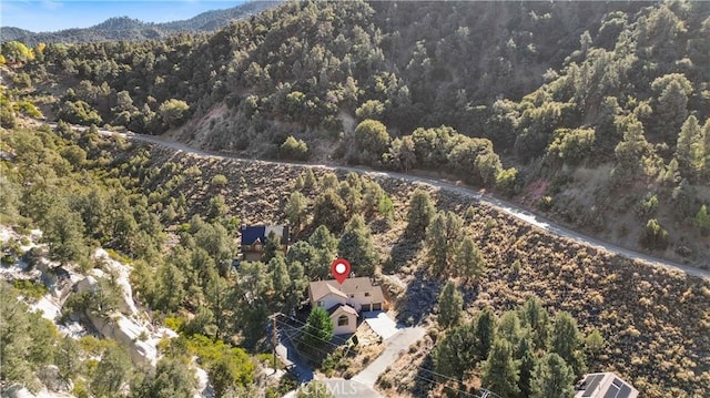 birds eye view of property with a wooded view