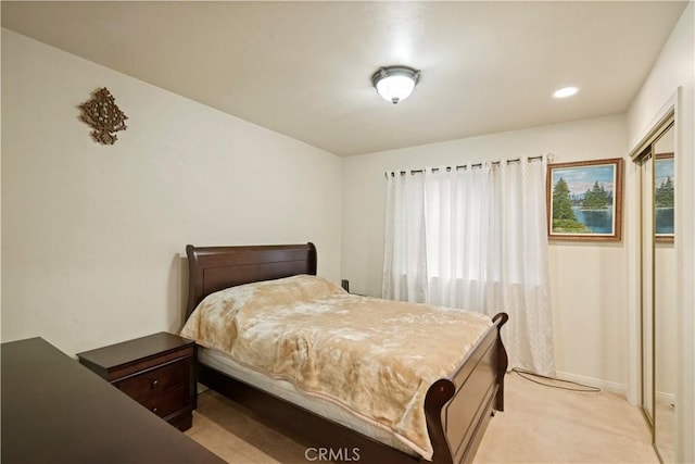 bedroom with baseboards and light colored carpet