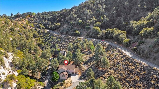 birds eye view of property with a wooded view