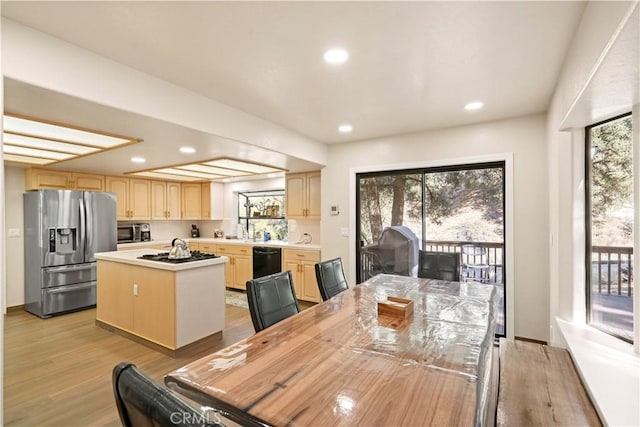 dining space featuring light wood-type flooring, a wealth of natural light, and recessed lighting