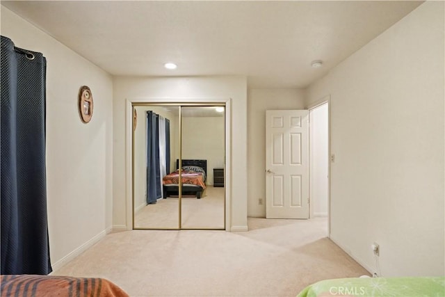 bedroom with carpet, baseboards, and a closet