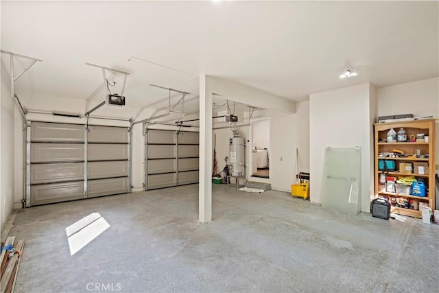 garage featuring a garage door opener, washer / dryer, and water heater