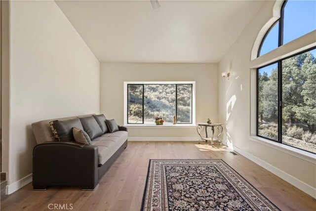 living area with wood finished floors and baseboards