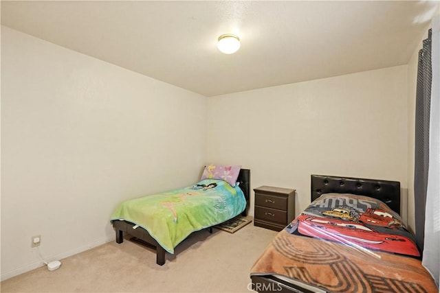 carpeted bedroom featuring baseboards