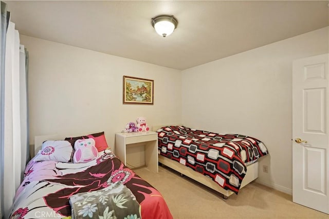 bedroom featuring carpet floors and baseboards