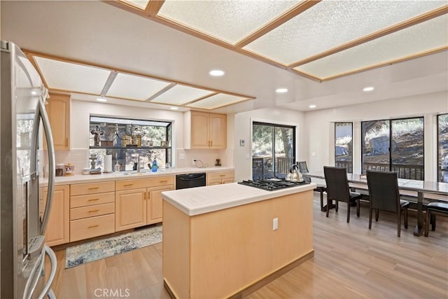 kitchen featuring black dishwasher, light brown cabinets, gas cooktop, and stainless steel refrigerator