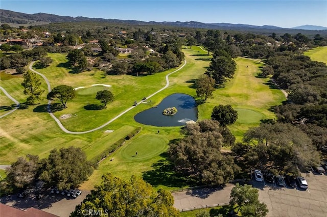 drone / aerial view featuring golf course view and a water and mountain view