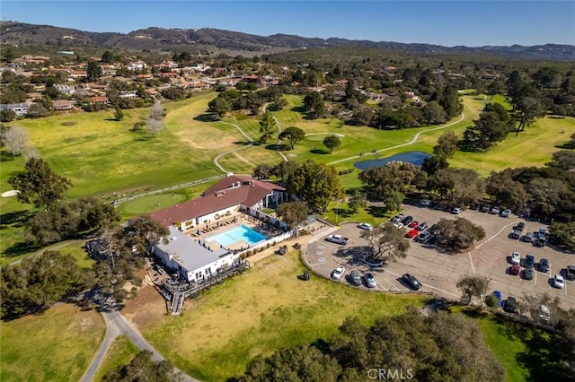 birds eye view of property featuring view of golf course and a mountain view
