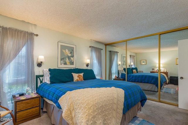 bedroom featuring carpet, a textured ceiling, and a closet