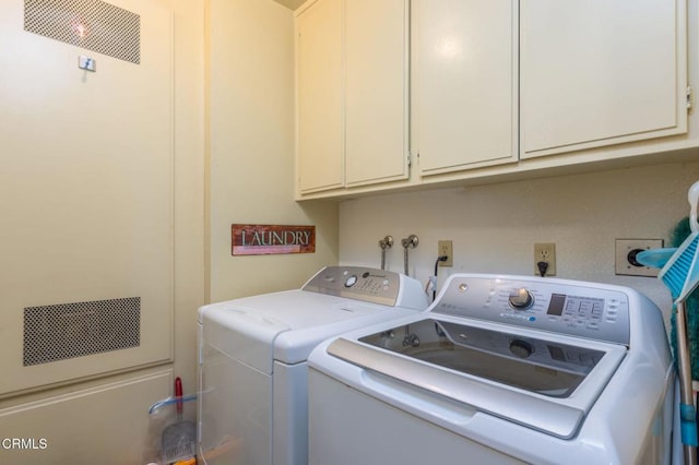 laundry room with cabinet space and washer and clothes dryer