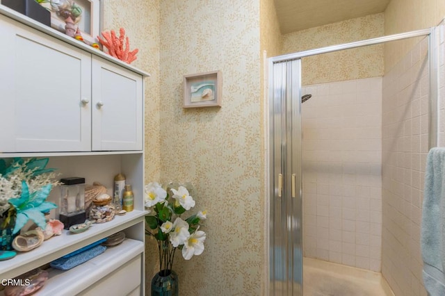 interior space featuring a shower stall and wallpapered walls