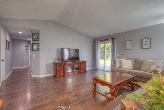 living area featuring vaulted ceiling, baseboards, and wood finished floors