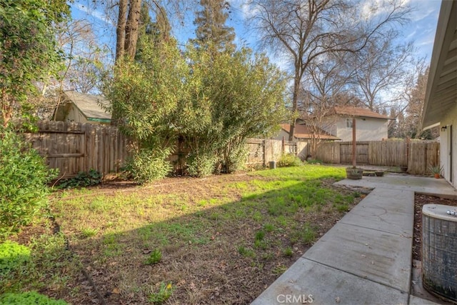 view of yard with a patio area, a fenced backyard, and central air condition unit