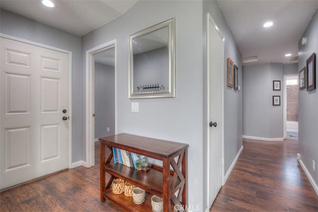 hall featuring recessed lighting, dark wood-style flooring, and baseboards